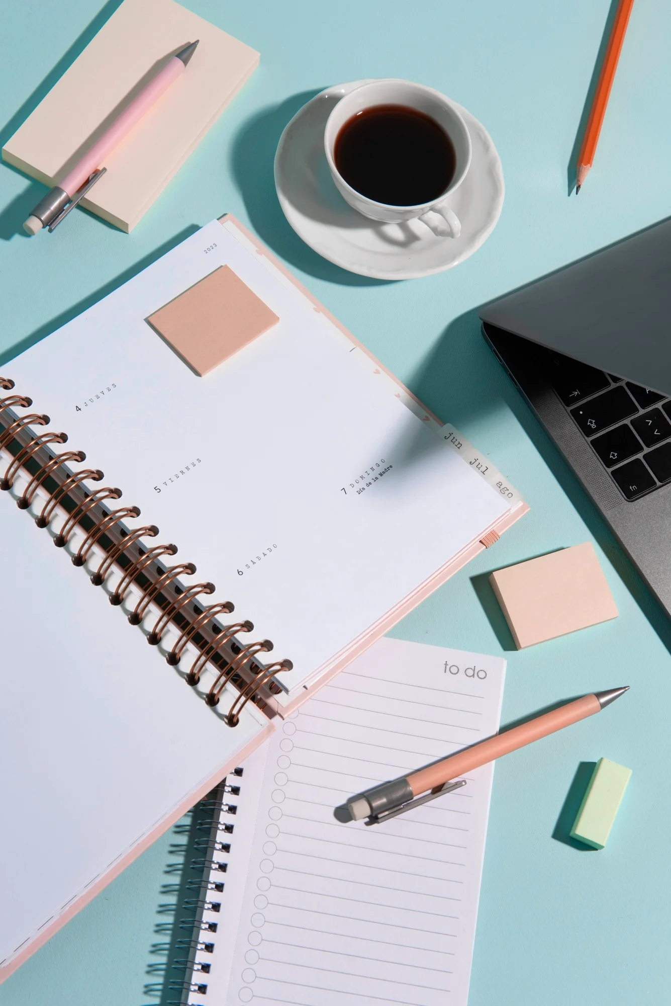 desk with notebooks and coffee