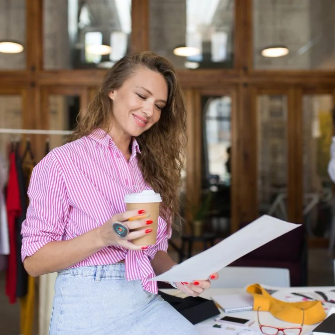 busines owner overlooking paperwork while smiling